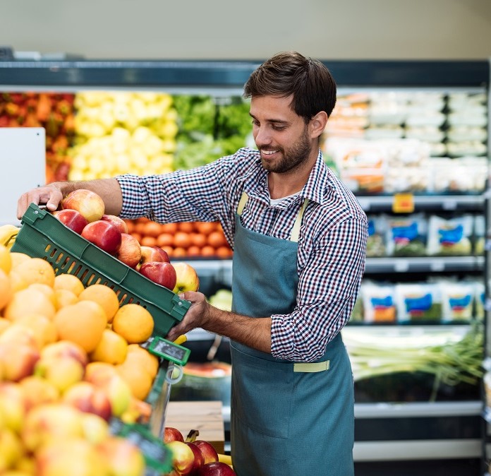 male employee stacking vegetables