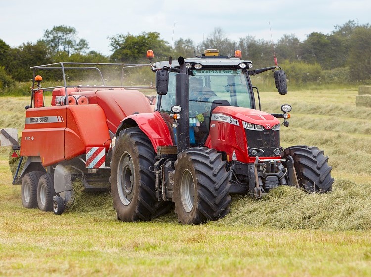 red tractor towing a trailer 