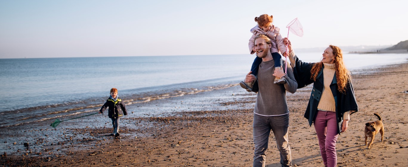 Family walking along beach